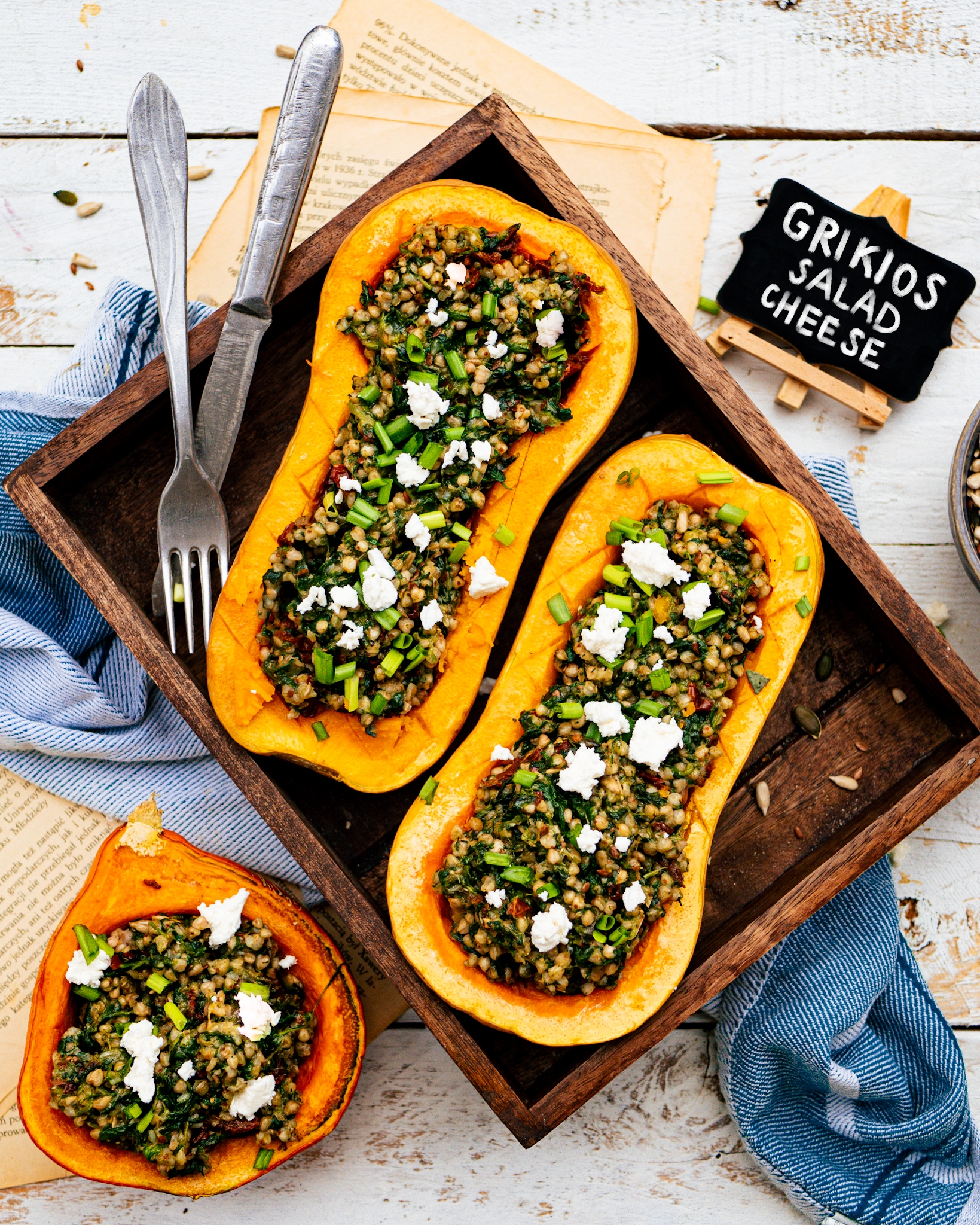Roasted pumpkin stuffed with white buckwheat with spinach and sun-dried tomatoes, sprinkled abundantly with chives and Grikios feta-type cheese